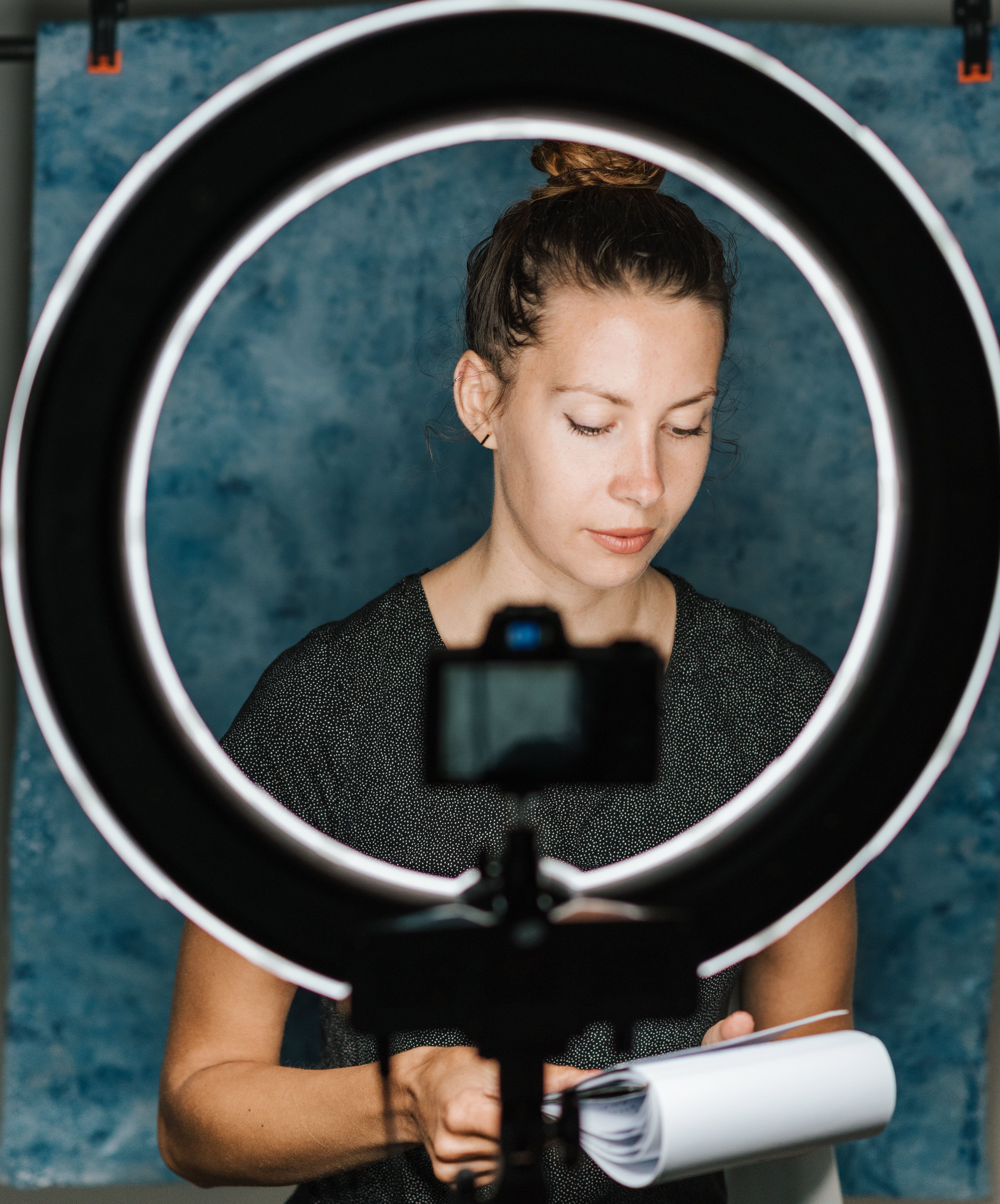 Content creator recording with a camera and ring light